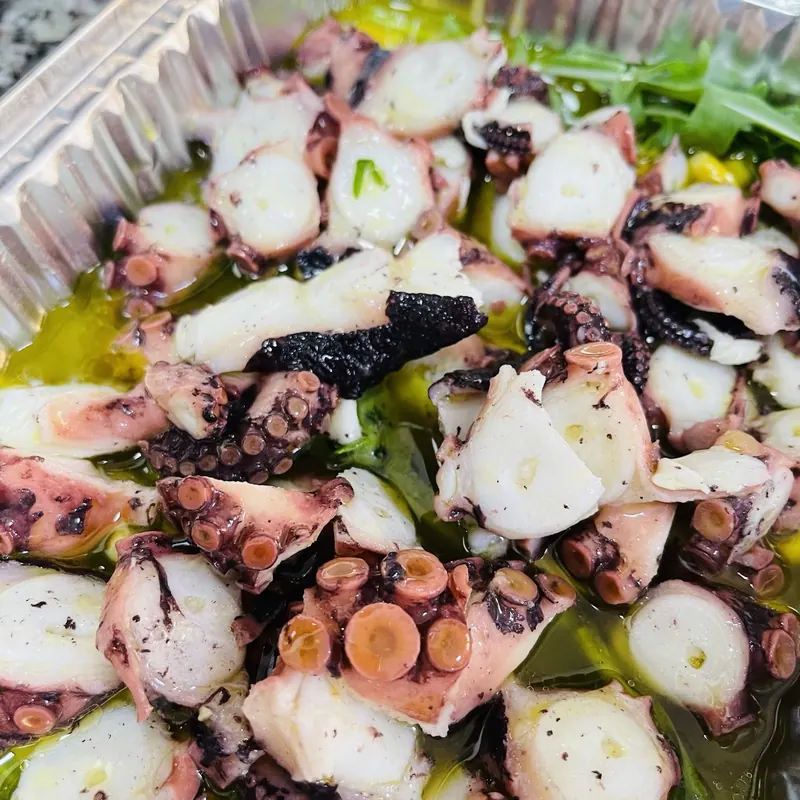 Octopus salad on rocket with olive oil