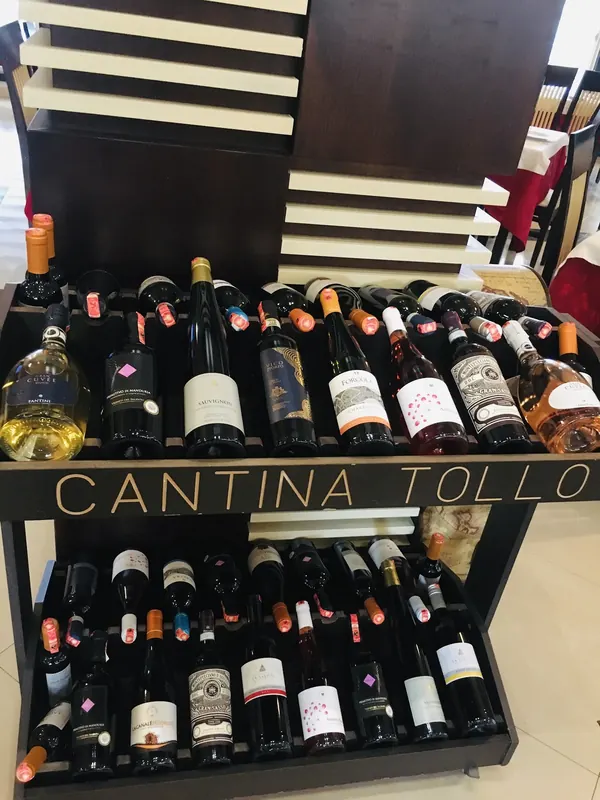 A wooden wine display stacked with bottles of red, white and rosé